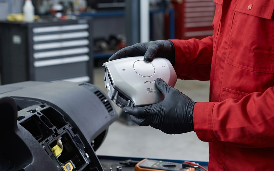 Technician repairing the airbag system of a Brabus at our Dubai workshop