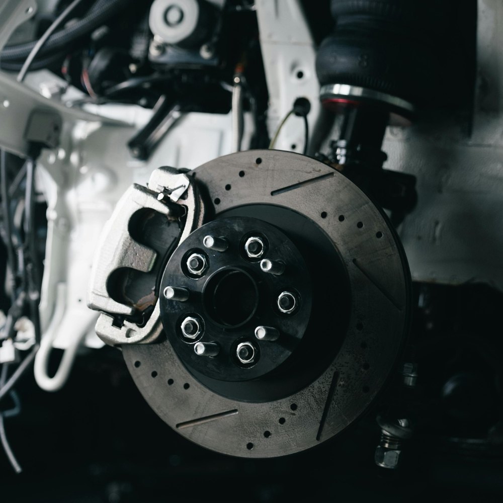 Drilled brake disc and caliper on a lifted car